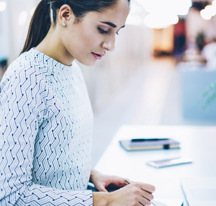 image of a girl at a desk writing